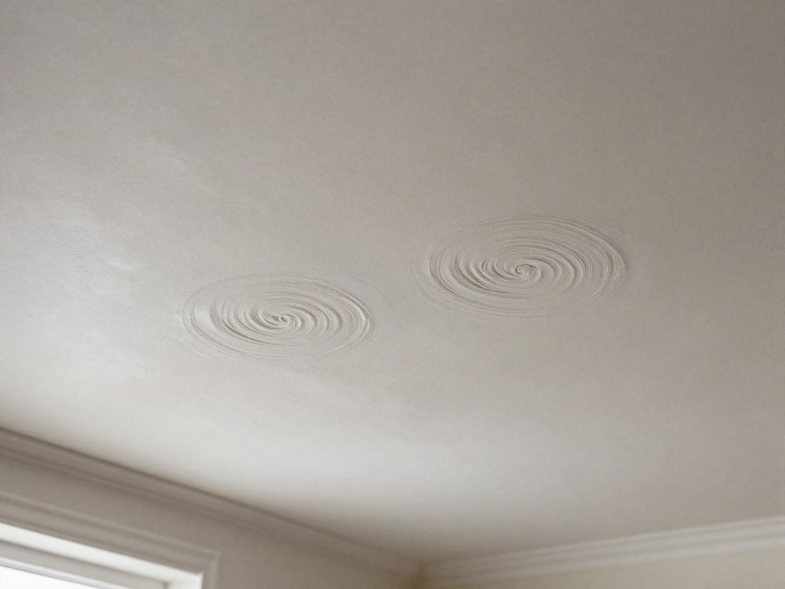 Textured swirl-patterned ceiling coating in a 1970s home